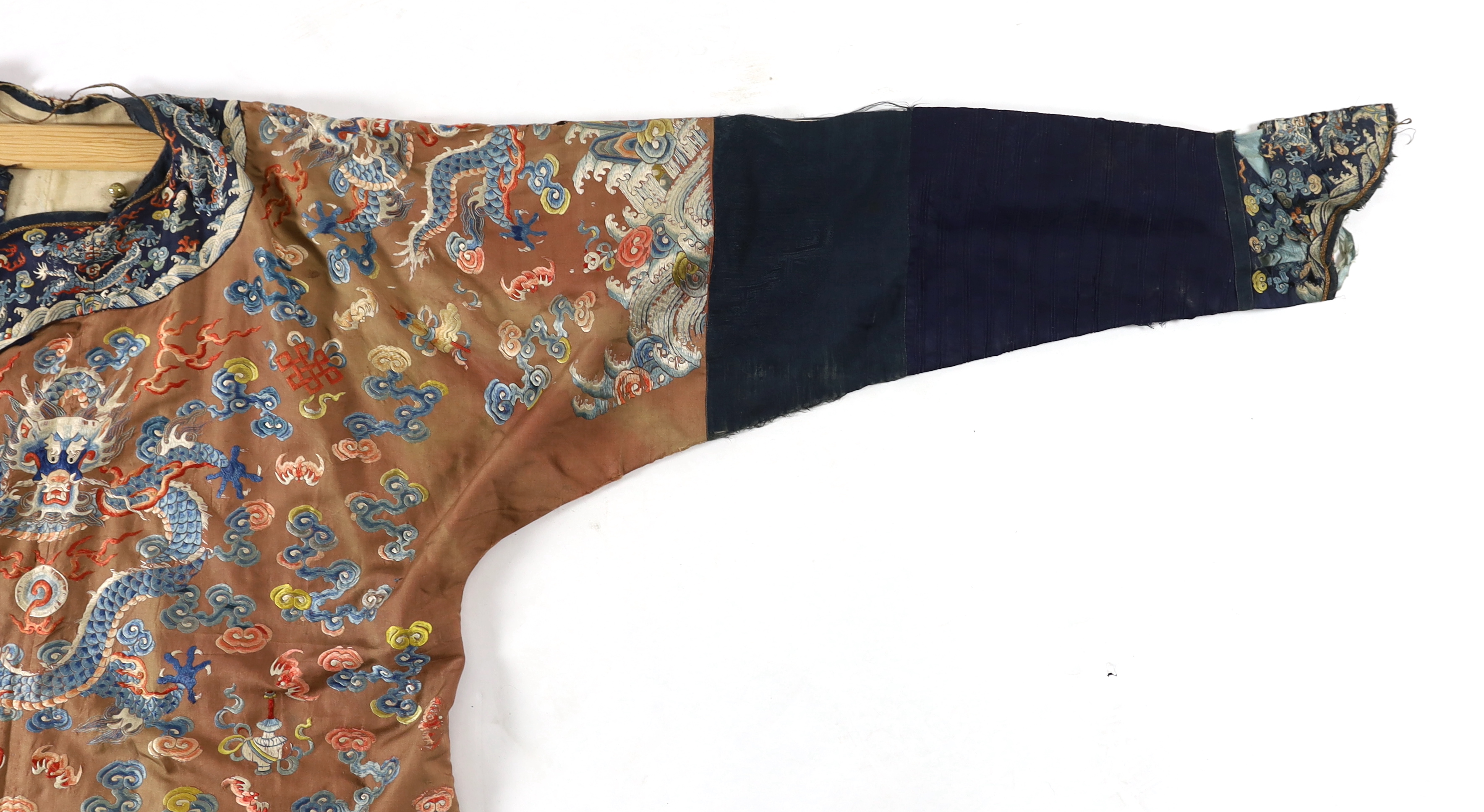 A Chinese chestnut-ground ‘nine dragon’ robe, jifu, 19th century, tears and losses